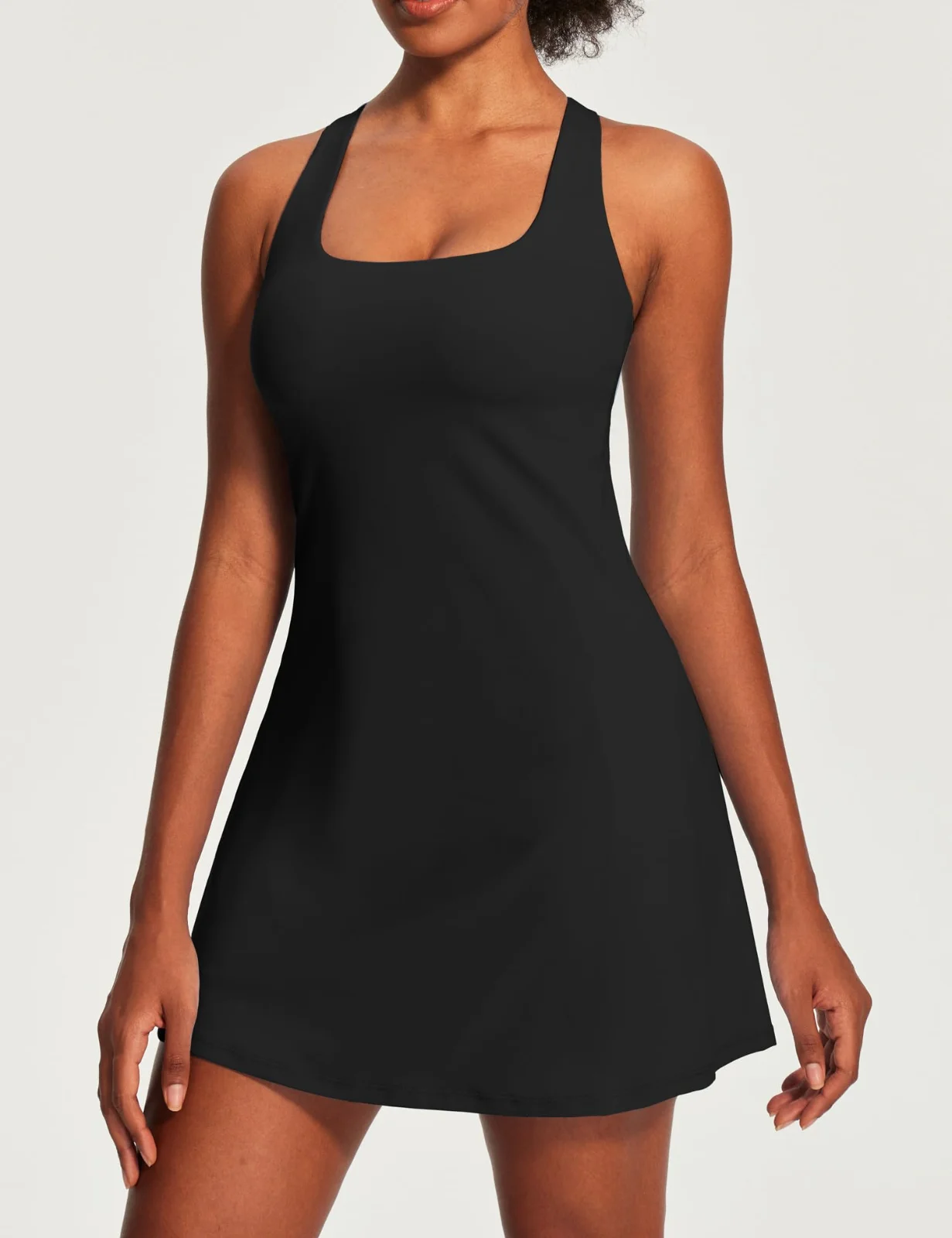 The square-neck tennis dress in black, photographed on white